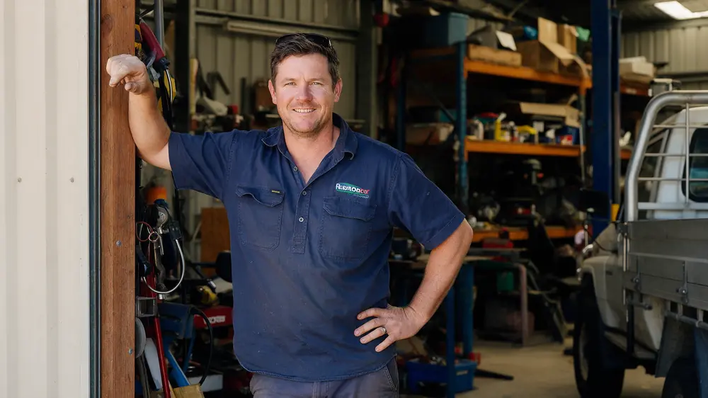 Australian small-business owner standing in the doorway of a workshop