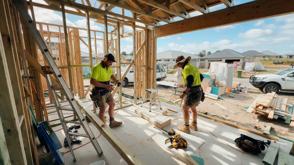 Tradespeople working on a timber-framed construction site