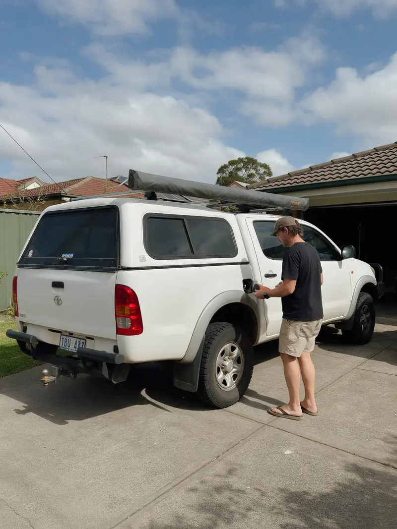 Person inspecting a four-wheel drive parked in an Australian driveway